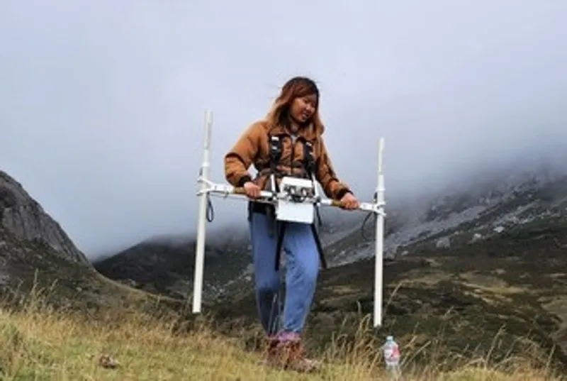Archaeology student doing experiment outdoors