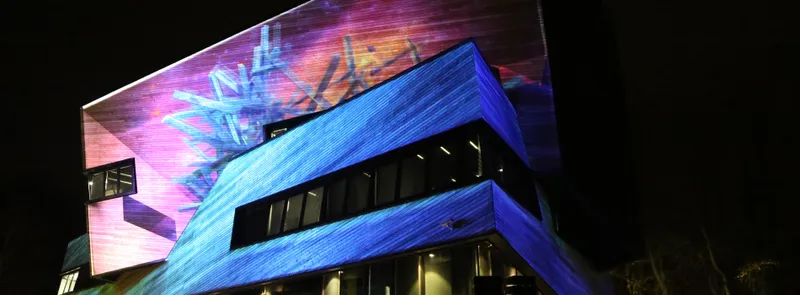 The Ogden Centre at night illuminated by light art