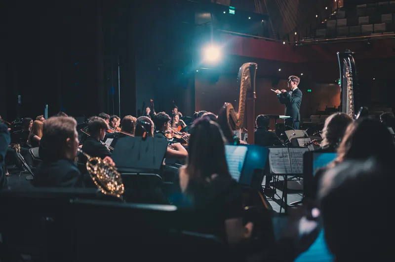 An orchestra performing at the Gala Theatre