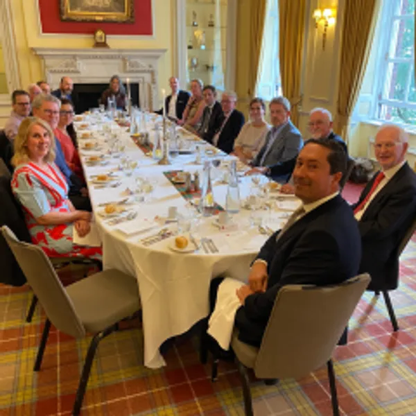 Alumni gathered around a table planning for the College 70th anniversary