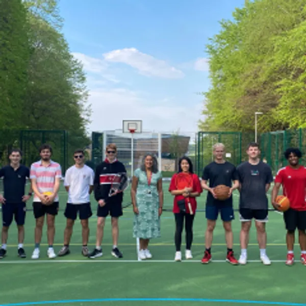 8 people standing on a sports field with Sonia Virdee