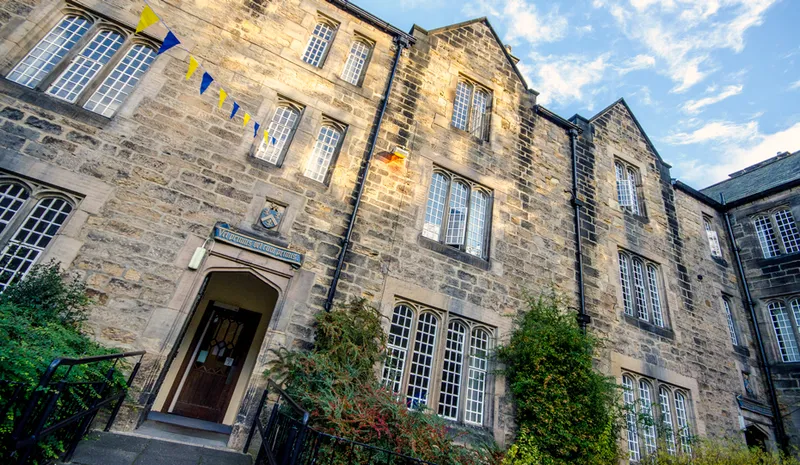 The steps into the Melville Building with the college motto and crest above