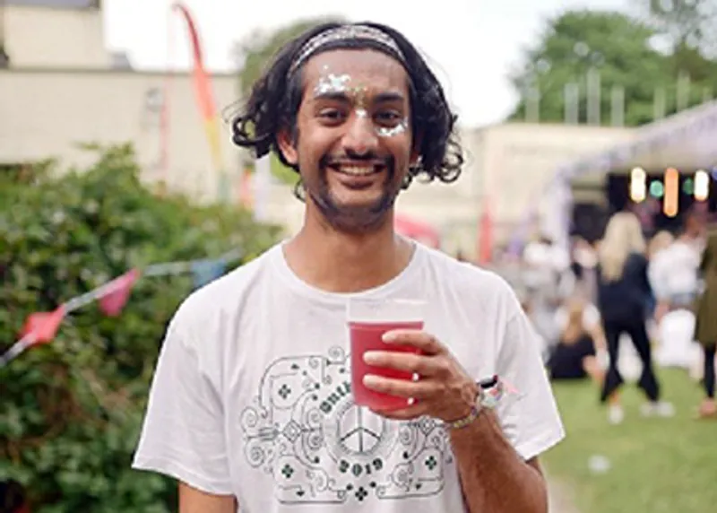 A student testimonial photograph of Rishi