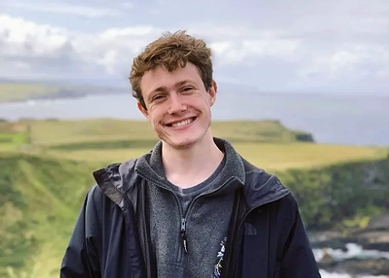 A student testimonial photograph of Ewan