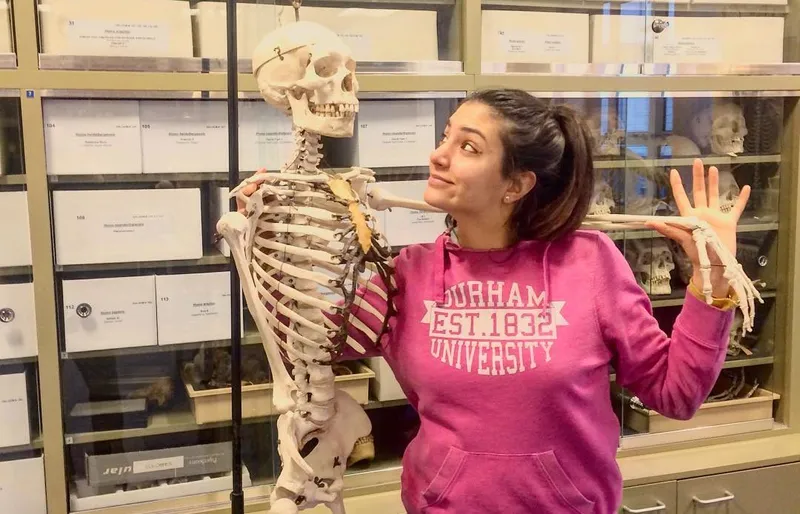 a person posing with a skeleton