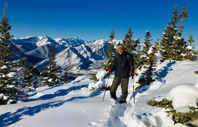 A person smiling for the camera whilst skiing