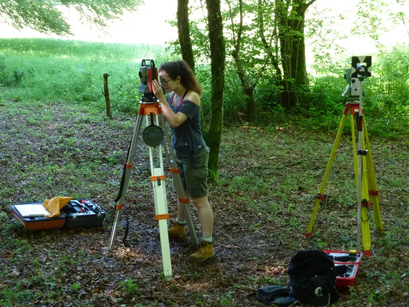 Someone on a field trip in a forest looking through a camera