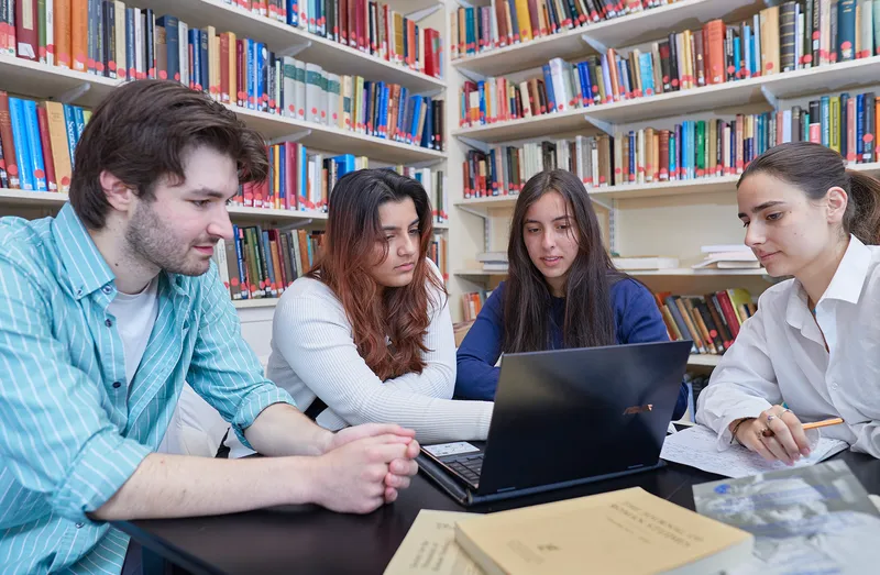 Classics students looking at laptop