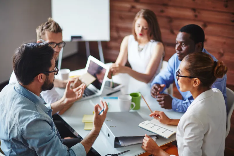 Group of people chatting at a team meeting