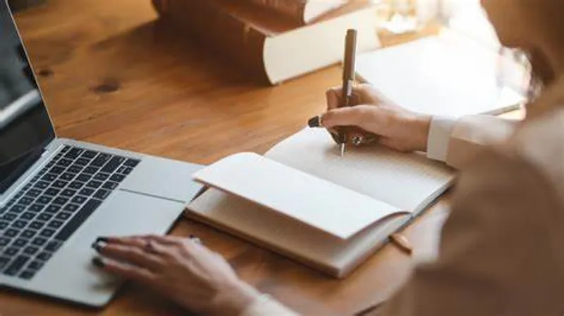 someone writing in a notepad