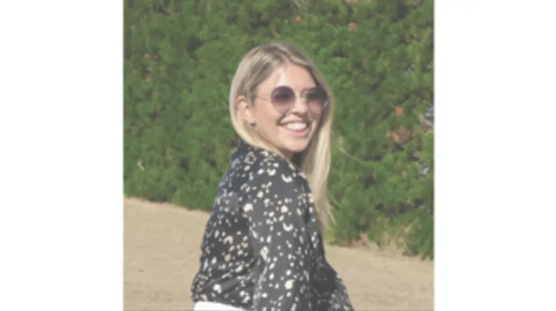 An image of a smiling woman with blonde hair.