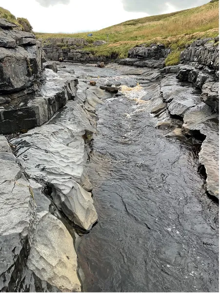 Exposed bedrock and sediment cover during low-flow summer conditions on Trout Beck at the Moor House Bedrock River Observatory, north Pennines.