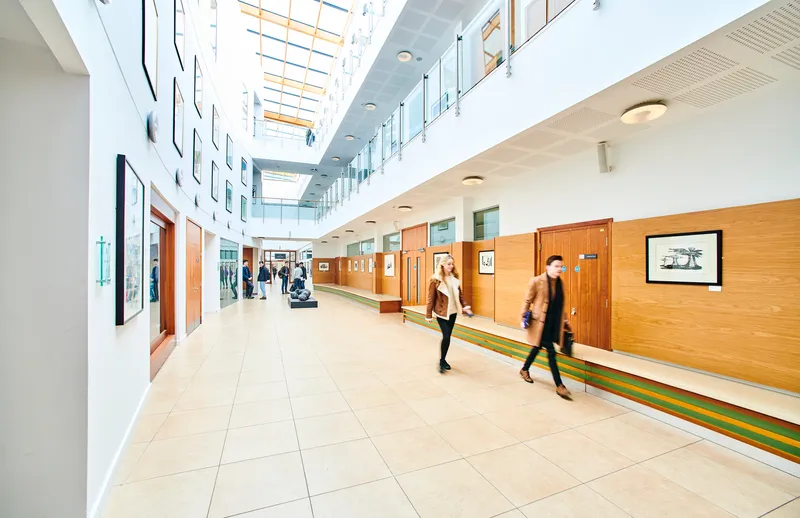 Students walking along law school hallway