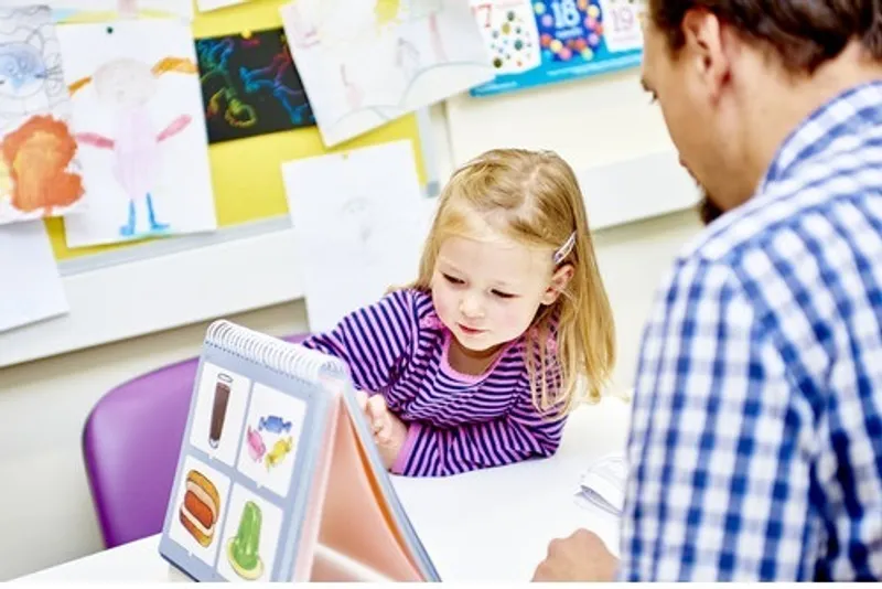 A child with researcher, taking part in a memory based experiment