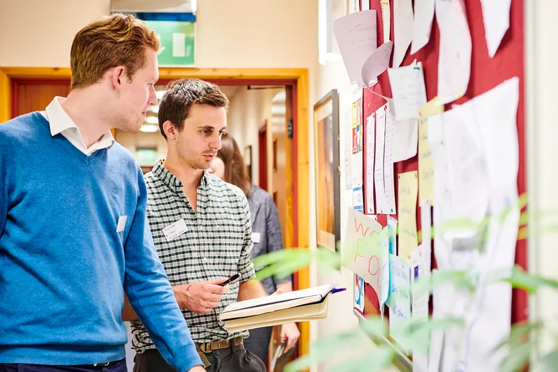 Students looking at a noticeboard