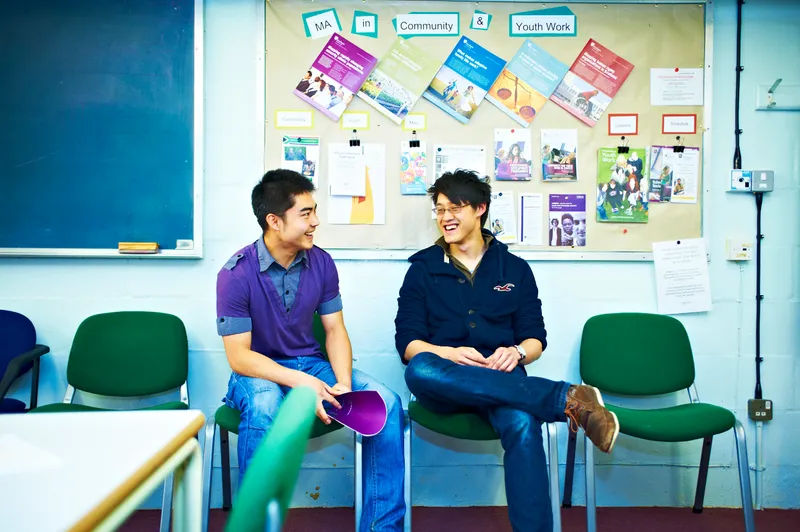 Two students in conversation during a seminar