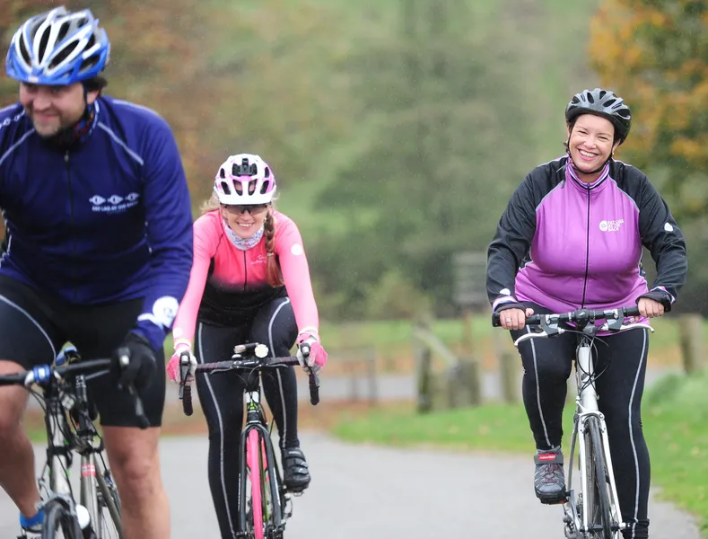 Three cyclists on road wearing helmets