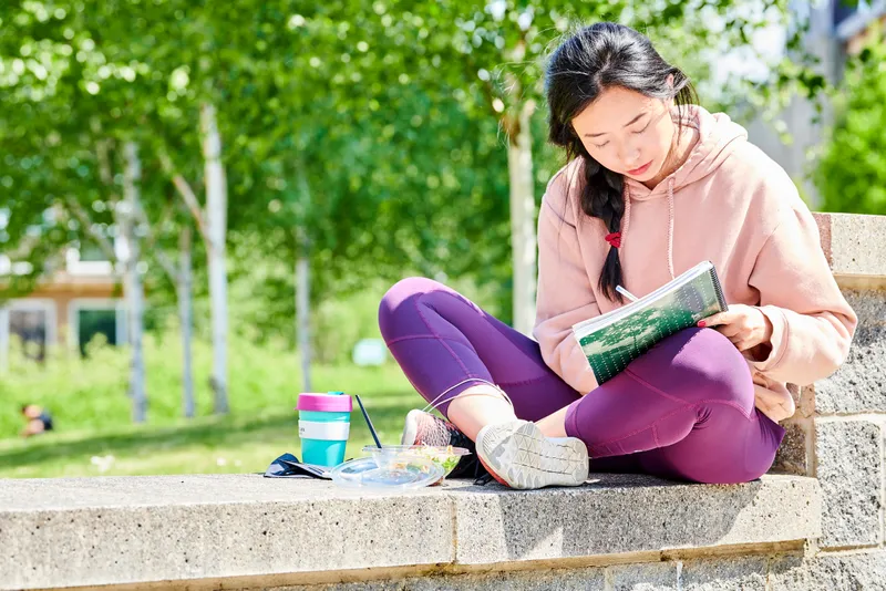 Student sat studying on campus