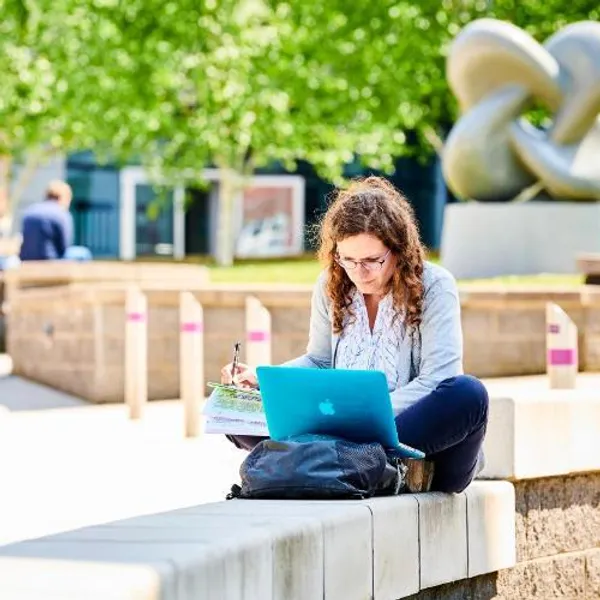 Student sat studying on campus