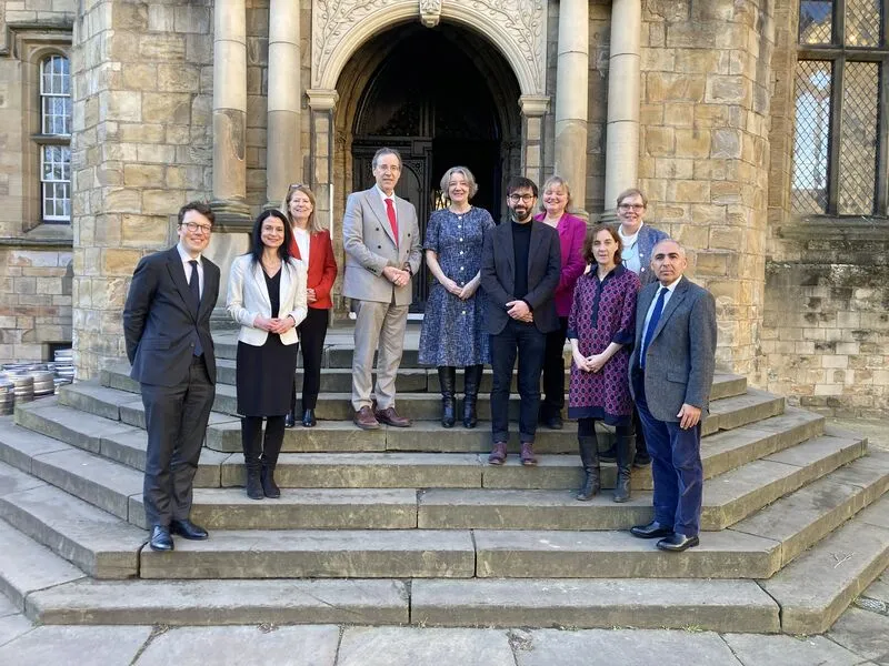 Group of ten people standing together smiling