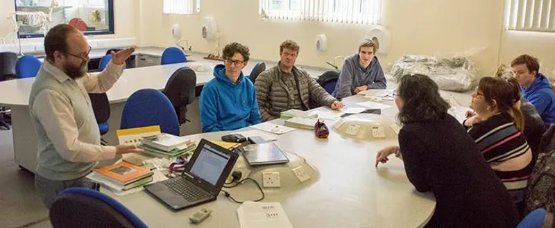 Academic assisting a group of people