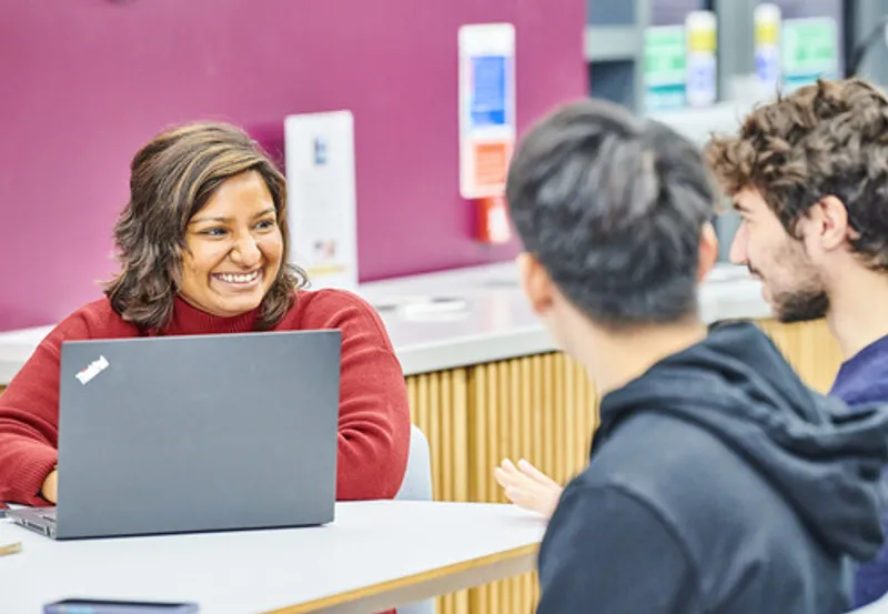 Staff and student chatting in Ustinov social space