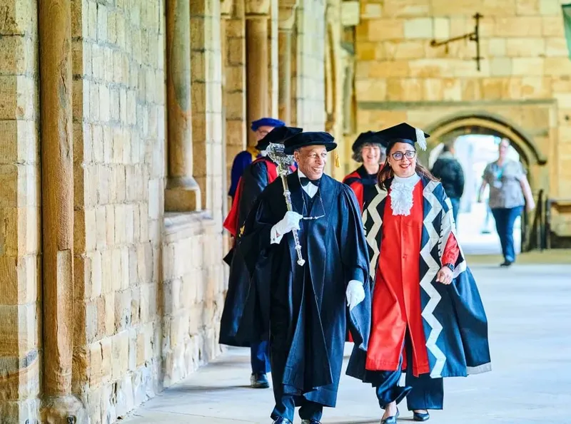 Congregation Staff Procession inside Durham Cathedral Cloisters
