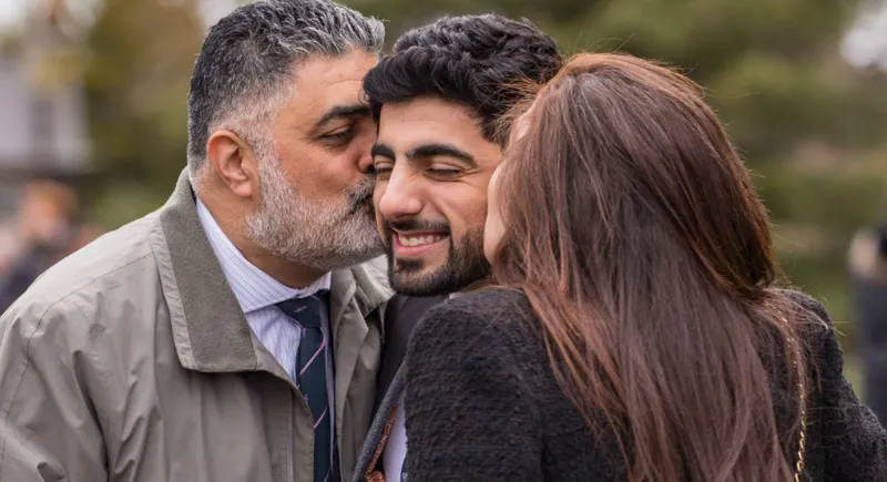 Parents embracing a graduating student