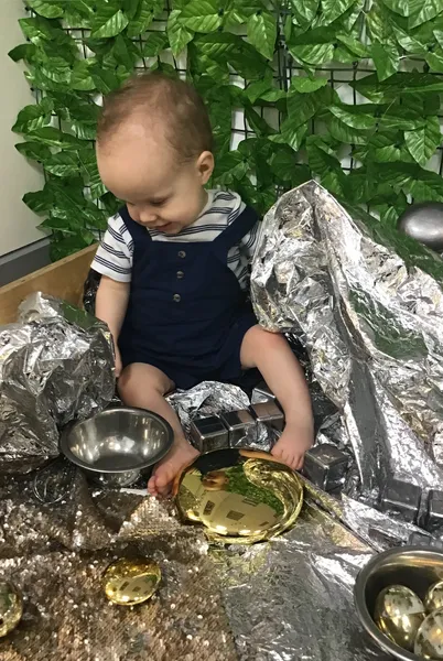 Children playing outside in sand pit