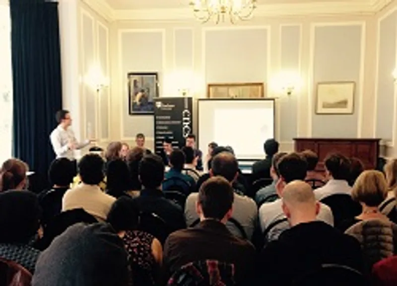 Speaker giving presentation to seated audience