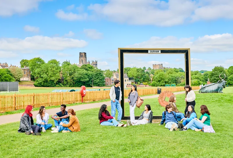 Students sitting on grass at Durham Maidan Castle