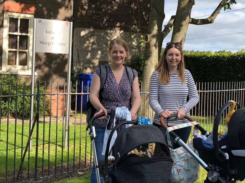 Two women and their babies outside of the Infancy and Sleep Centre
