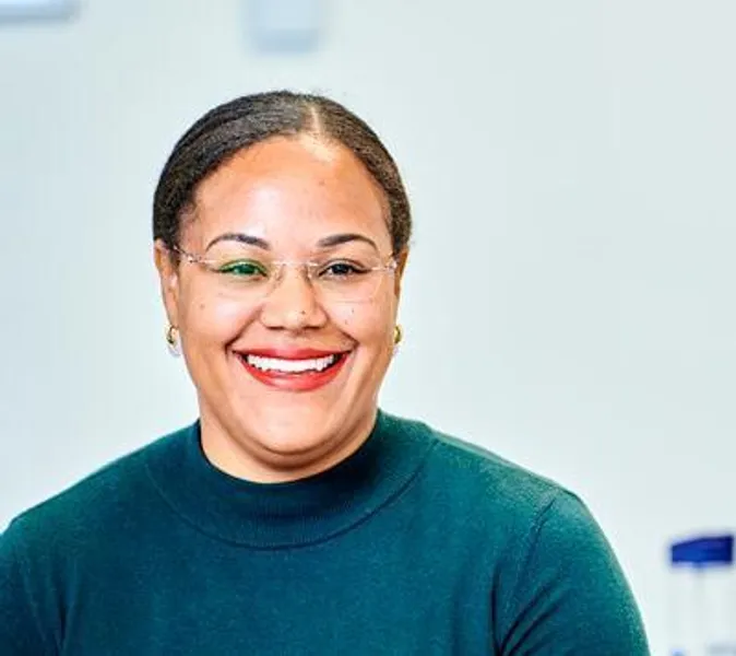 A smiling woman in conversation with someone