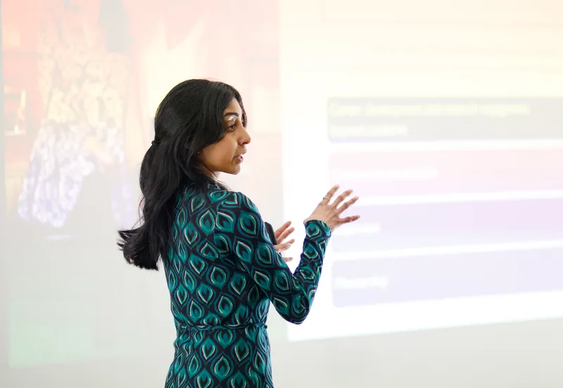 Research presenting in front of a large screen