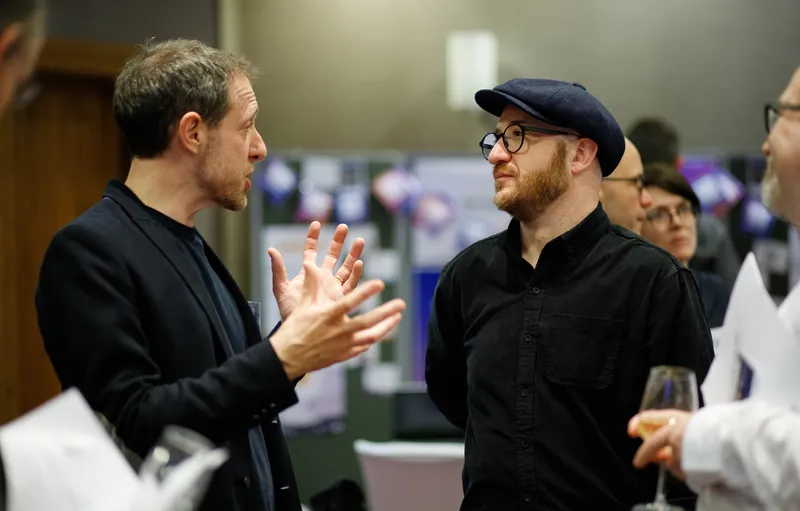 Researchers engaged in lively discussion at the DRP Launch