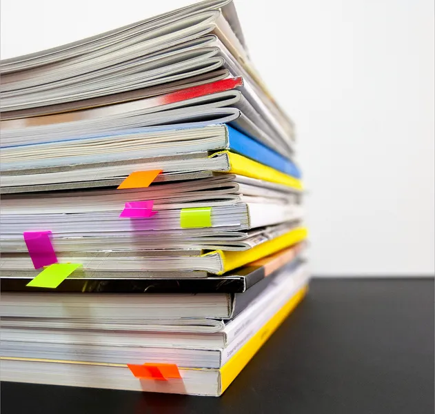 A pile of reports on a table.