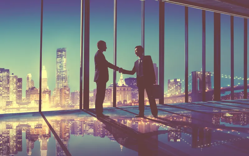 Business handshake in front of city skyline, for result corporate law