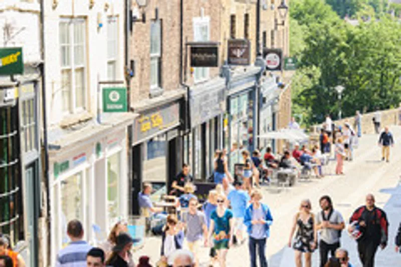 A view of part of Durham city centre busy with people.