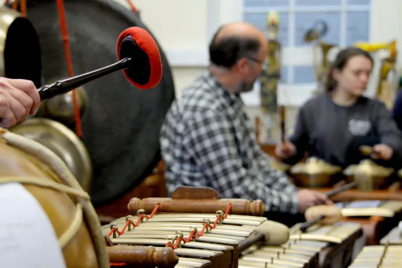 Gamelan rehearsal with tuned gongs, metallophones and drums