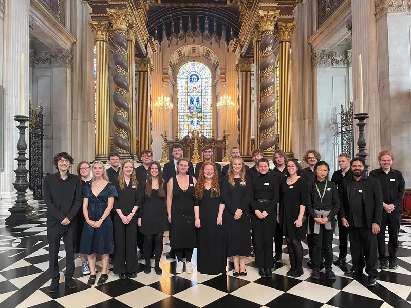Choral singers posing for a photo on tour