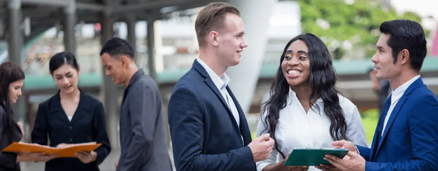 Man in business suit talking to female colleague