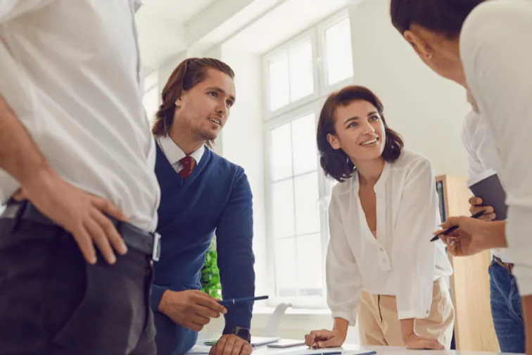 Business people stood around a table