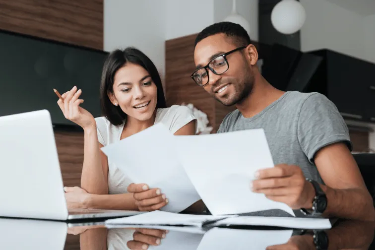 Two people looking at finance papers