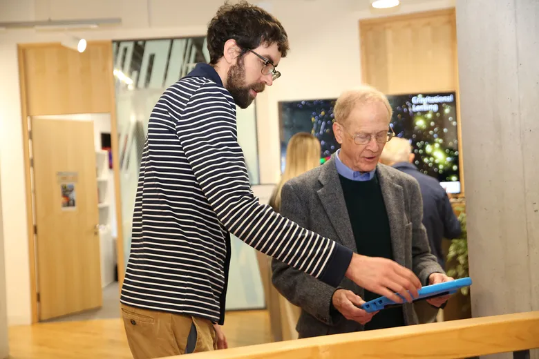 Two people using an ipad