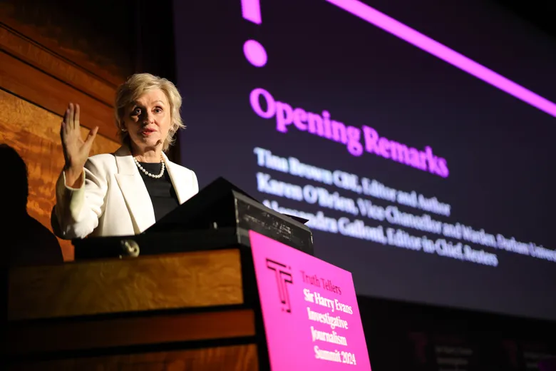 Woman standing behind lectern, giving speech