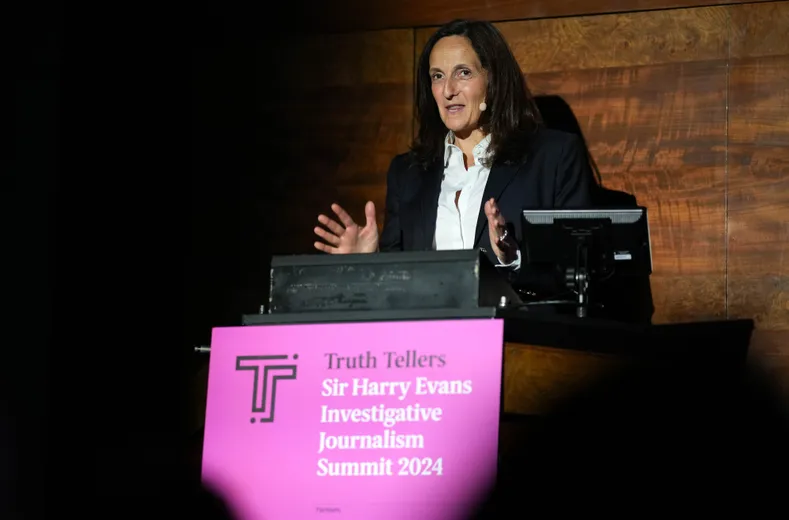 Woman standing behind lectern, giving speech