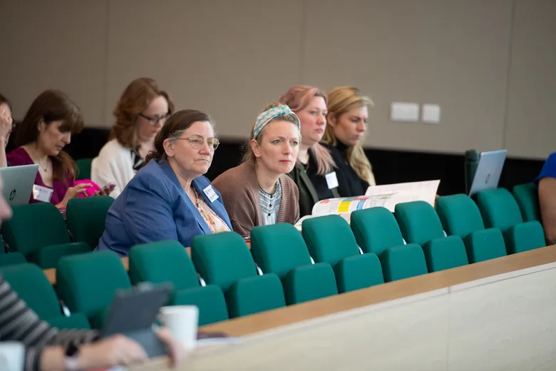 People sitting in theatre-style seats