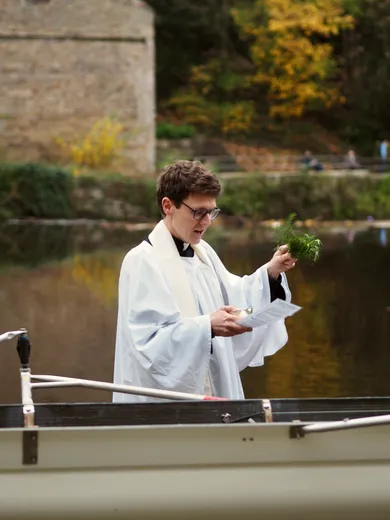 A clergyman blessing a boat