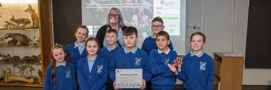 Schoolchildren collect a certificate