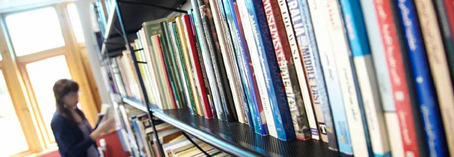 Person browsing books in a library